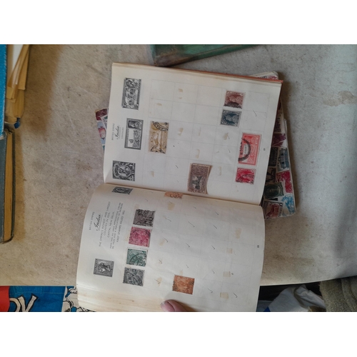136 - Stamps: a box of stamps albums, ice cream carton of stamps on paper and loose, mixed era world stamp... 