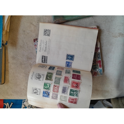 136 - Stamps: a box of stamps albums, ice cream carton of stamps on paper and loose, mixed era world stamp... 