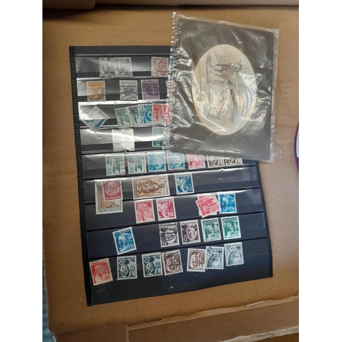 136 - Stamps: a box of stamps albums, ice cream carton of stamps on paper and loose, mixed era world stamp... 