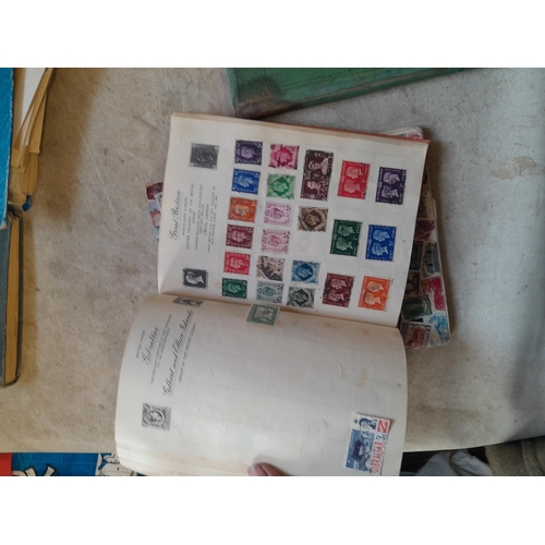 136 - Stamps: a box of stamps albums, ice cream carton of stamps on paper and loose, mixed era world stamp... 