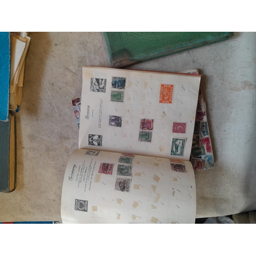 136 - Stamps: a box of stamps albums, ice cream carton of stamps on paper and loose, mixed era world stamp... 