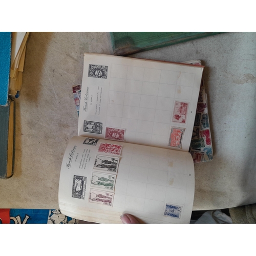 136 - Stamps: a box of stamps albums, ice cream carton of stamps on paper and loose, mixed era world stamp... 