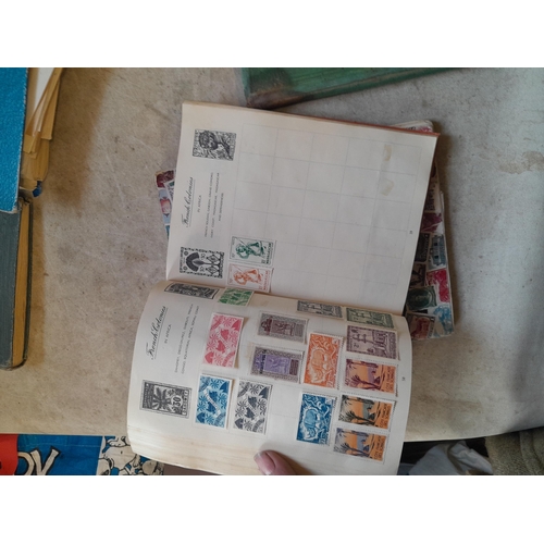 136 - Stamps: a box of stamps albums, ice cream carton of stamps on paper and loose, mixed era world stamp... 