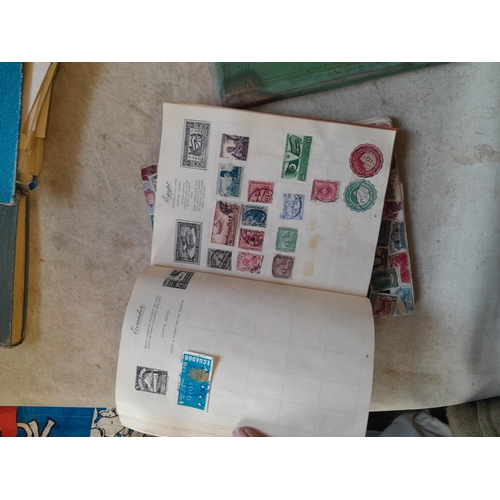 136 - Stamps: a box of stamps albums, ice cream carton of stamps on paper and loose, mixed era world stamp... 