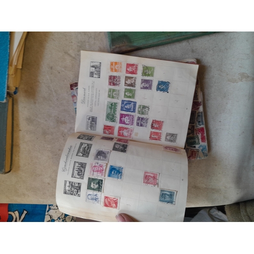 136 - Stamps: a box of stamps albums, ice cream carton of stamps on paper and loose, mixed era world stamp... 