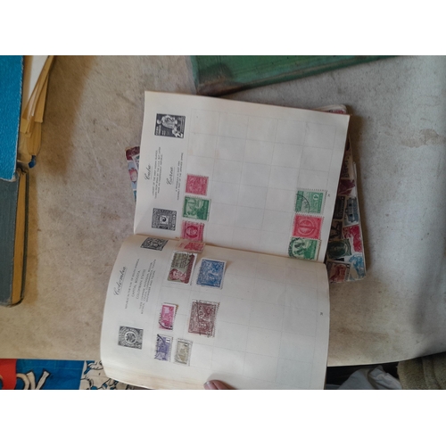 136 - Stamps: a box of stamps albums, ice cream carton of stamps on paper and loose, mixed era world stamp... 