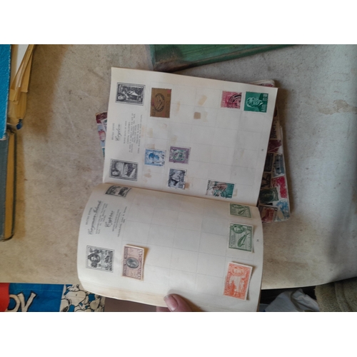 136 - Stamps: a box of stamps albums, ice cream carton of stamps on paper and loose, mixed era world stamp... 