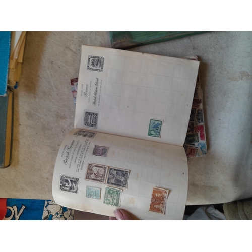 136 - Stamps: a box of stamps albums, ice cream carton of stamps on paper and loose, mixed era world stamp... 