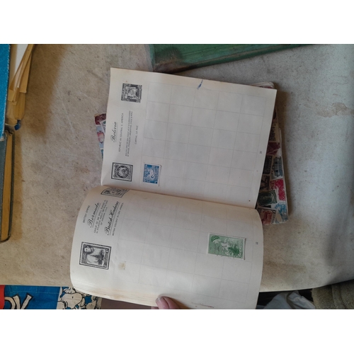 136 - Stamps: a box of stamps albums, ice cream carton of stamps on paper and loose, mixed era world stamp... 