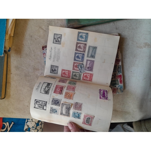 136 - Stamps: a box of stamps albums, ice cream carton of stamps on paper and loose, mixed era world stamp... 