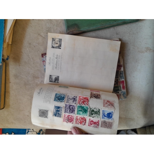 136 - Stamps: a box of stamps albums, ice cream carton of stamps on paper and loose, mixed era world stamp... 