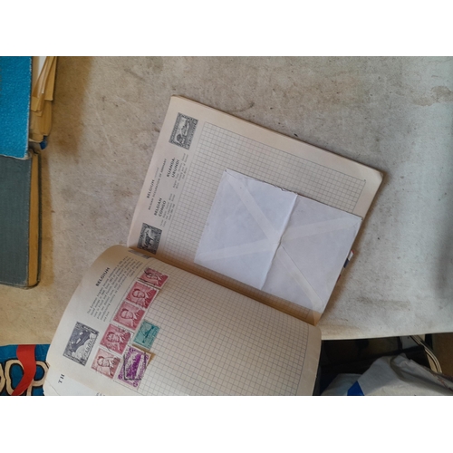 136 - Stamps: a box of stamps albums, ice cream carton of stamps on paper and loose, mixed era world stamp... 