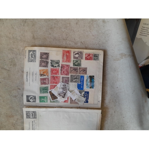 136 - Stamps: a box of stamps albums, ice cream carton of stamps on paper and loose, mixed era world stamp... 
