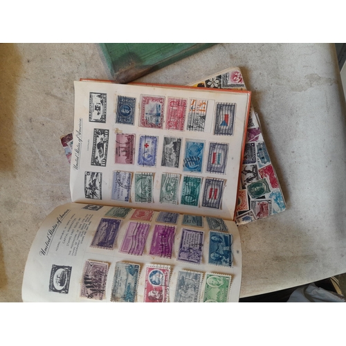 136 - Stamps: a box of stamps albums, ice cream carton of stamps on paper and loose, mixed era world stamp... 