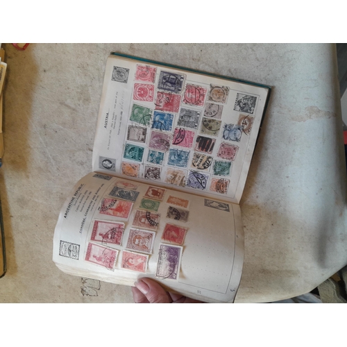 136 - Stamps: a box of stamps albums, ice cream carton of stamps on paper and loose, mixed era world stamp... 
