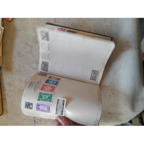 136 - Stamps: a box of stamps albums, ice cream carton of stamps on paper and loose, mixed era world stamp... 