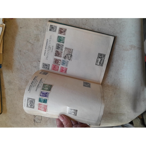 136 - Stamps: a box of stamps albums, ice cream carton of stamps on paper and loose, mixed era world stamp... 