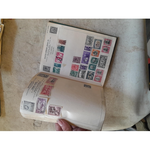 136 - Stamps: a box of stamps albums, ice cream carton of stamps on paper and loose, mixed era world stamp... 