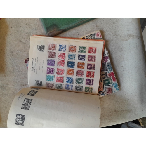 136 - Stamps: a box of stamps albums, ice cream carton of stamps on paper and loose, mixed era world stamp... 