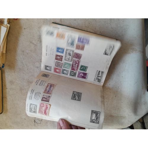 136 - Stamps: a box of stamps albums, ice cream carton of stamps on paper and loose, mixed era world stamp... 