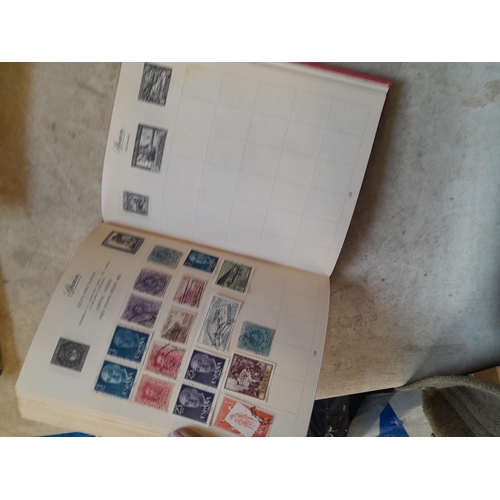 136 - Stamps: a box of stamps albums, ice cream carton of stamps on paper and loose, mixed era world stamp... 