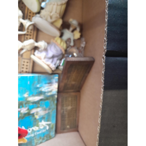 148 - Box of assorted puzzles, reproduction folding cribbage boards, resin figures etc.