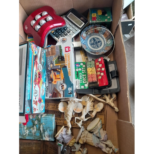 148 - Box of assorted puzzles, reproduction folding cribbage boards, resin figures etc.