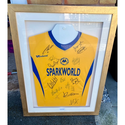 231 - Signed Torquay United Football shirt behind perspex