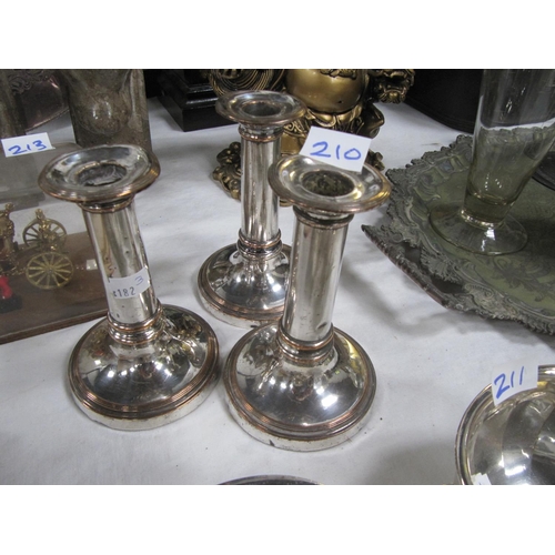 210 - A Trio of Silver on Copper Candlesticks.