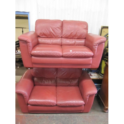 703 - Two Red Leather Two Seater Settees.