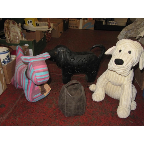 24 - Two Dog Door Stops, Dog Shaped Candle Lantern & One Other Door Stop.