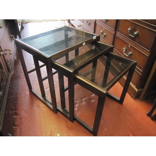 609 - Nest of Three Smokey Glass & Mahogany Tables.