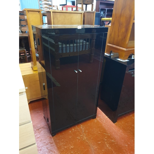 573 - Black Gloss Finish Two Fold Out Door DVD Cabinet.