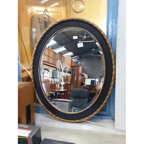 433 - Gilt & Black Framed Oval Wall Mirror.