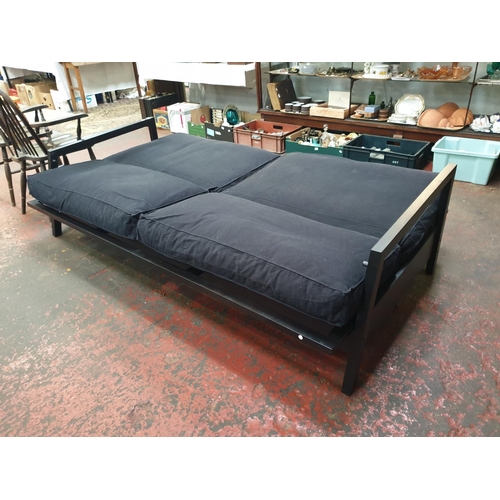 491 - Black Two Seater Fold Out Sofa Bed.