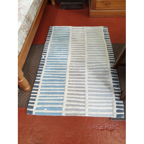 495 - Blue & White Patterned Rug.