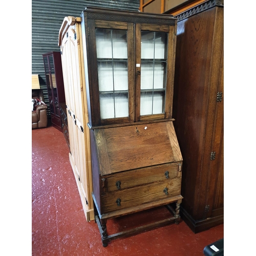 511 - Solid Oak Glazed Top Bureau Bookcase Over Two Drawers.