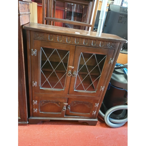 567 - Shallow Old Oak Four Door Bookcase with Two Glazed Doors over Two Solid Doors.