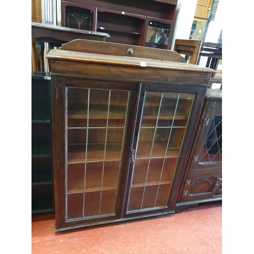 568 - Oak Glazed Two Door Cabinet.