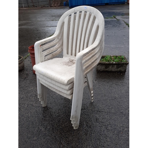 692 - Four White Stacking Plastic Patio Chairs.