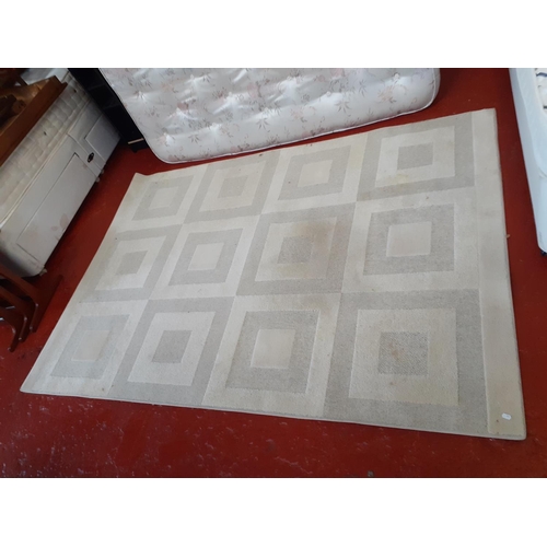 502 - Rectangular Cream Patterned Rug approx 2.3m x 1.6m.