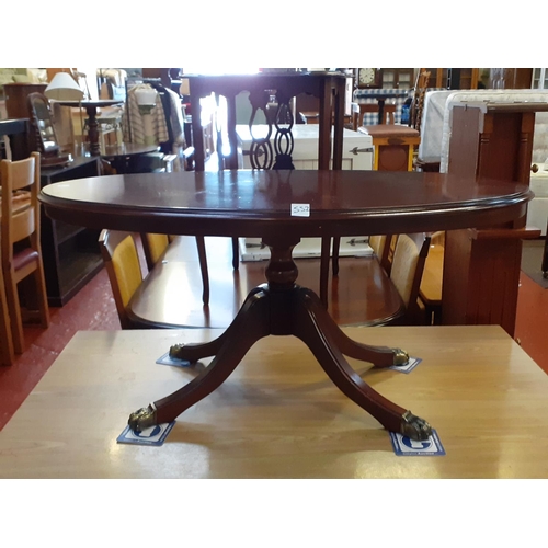 552 - Oval Mahogany Coffee Table on Brass Claw feet.