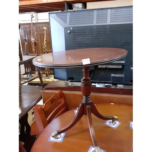 563 - Mahogany Oval Coffee Table on Brass Ball & Claw Feet.