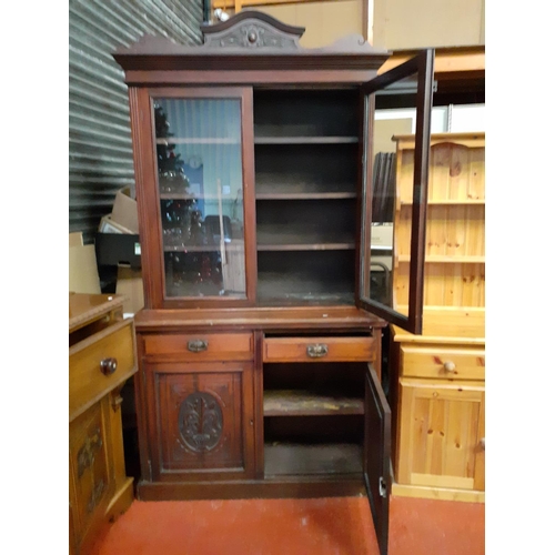 552 - Mahogany Glazed Top Bookcase Over 2 Drawers and Double Cupboard with Carved Doors.