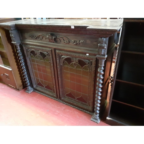 614 - Large Dark Oak Carved Unit, with Two Leaded Stained Glass Doors, Barley Twist Columns and Two Shelve... 