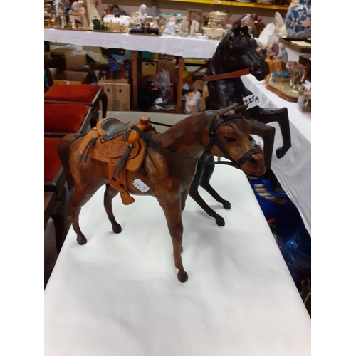 225A - Two Leather Clad Horse Figures - each approx 12