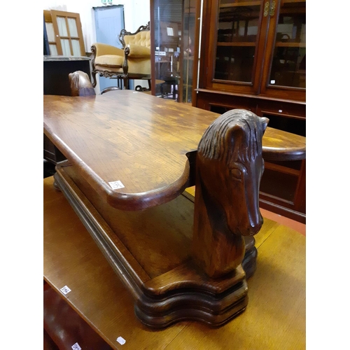 595 - Solid Oak Two Tier Coffee Table with Horse Head Carvings Either End.