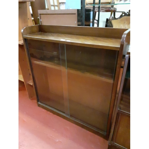 600 - Oak Sliding Glass Door Bookcase with Adjustable Shelves.