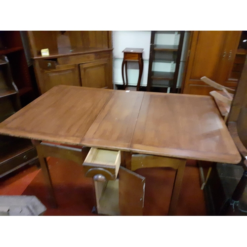 495 - Drop Leaf Oak Dining Table with Central Storage Door and Cupboard.