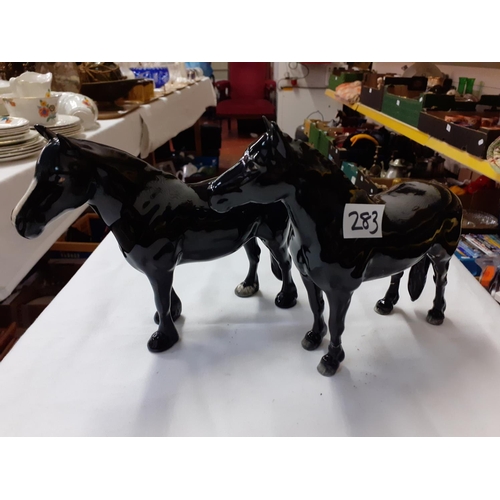 283 - Two Black Beswick Horses - both have repairs to legs.